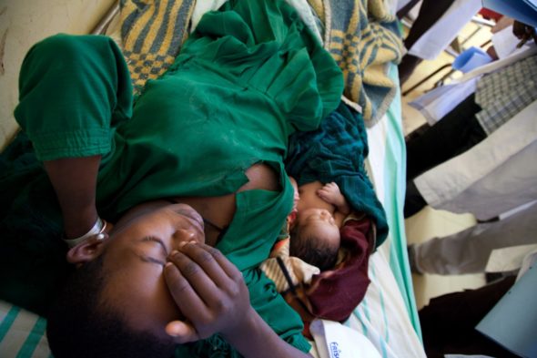 A mother contemplates her long walk home after surgery in Motta, Ethiopia (For the Barbara May Foundation)